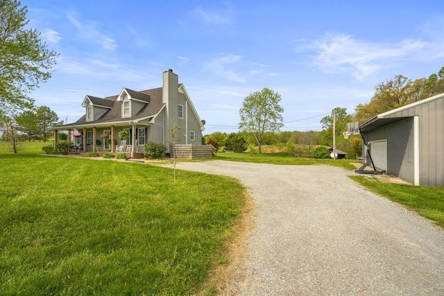view of side of home with a chimney, a yard, driveway, covered porch, and a garage