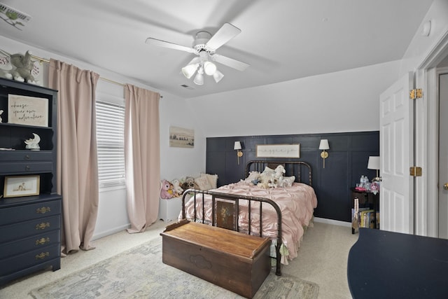 carpeted bedroom featuring a ceiling fan and visible vents