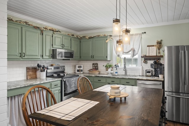 kitchen with decorative backsplash, green cabinetry, stainless steel appliances, and a sink