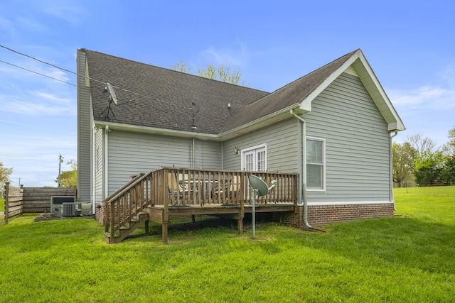 back of property featuring a shingled roof, a yard, cooling unit, and a deck