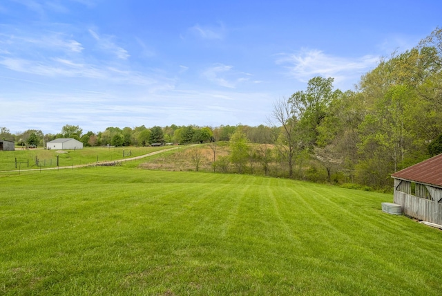 view of yard featuring fence and a rural view