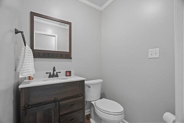half bath with wood finished floors, vanity, baseboards, toilet, and ornamental molding
