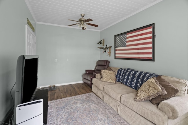living area featuring a ceiling fan, baseboards, ornamental molding, and wood finished floors