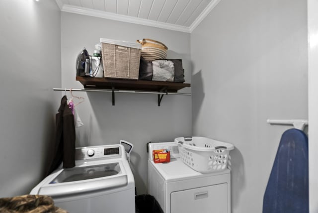 laundry room with washing machine and clothes dryer, wood ceiling, laundry area, and ornamental molding