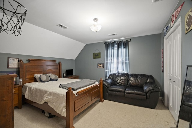 bedroom featuring vaulted ceiling, visible vents, and light carpet