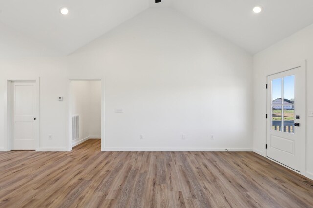236 Amos Cir, Lafayette, TN 37083 - spare room with high vaulted ceiling, visible vents, light wood-type flooring, and baseboards