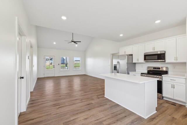 200 Amos Cir, Lafayette, TN 37083 - kitchen with appliances with stainless steel finishes, ceiling fan, vaulted ceiling, white cabinets, and light countertops