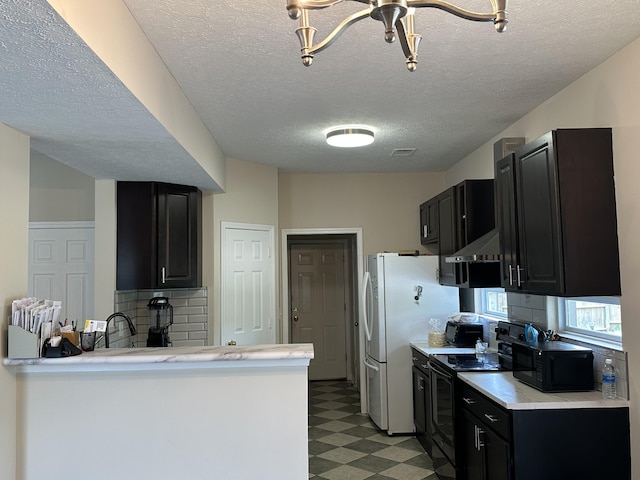 8257 Ramstone Way, Antioch, TN 37013 - kitchen with light countertops, black appliances, light floors, and dark cabinets