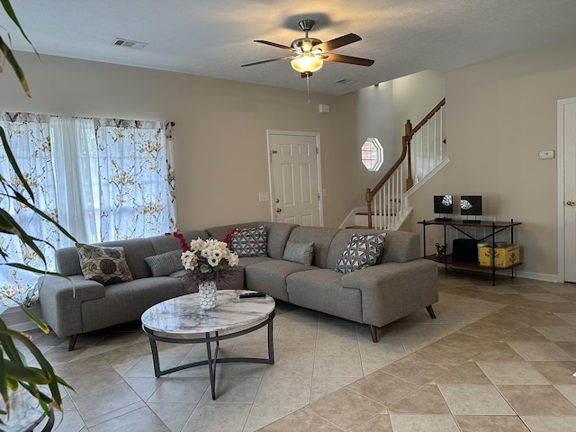 8257 Ramstone Way, Antioch, TN 37013 - living room with a textured ceiling, ceiling fan, visible vents, and stairway