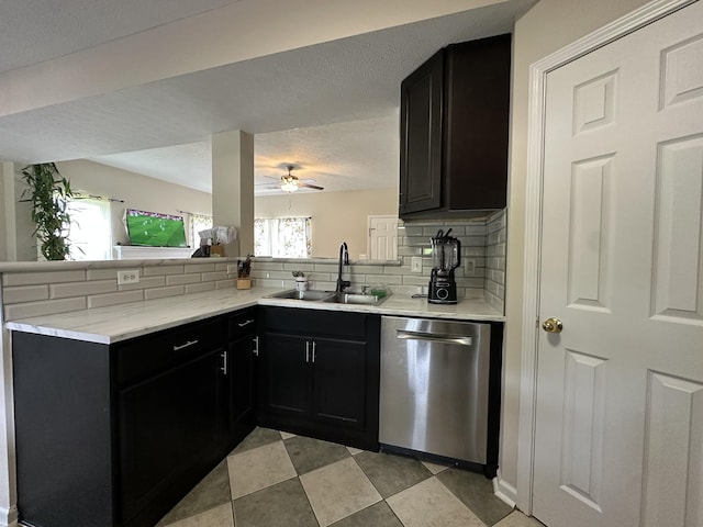8257 Ramstone Way, Antioch, TN 37013 - kitchen featuring dark cabinets, tasteful backsplash, a peninsula, dishwasher, and a sink