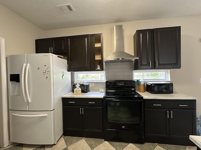 8257 Ramstone Way, Antioch, TN 37013 - kitchen featuring visible vents, wall chimney range hood, light countertops, dark cabinets, and black appliances