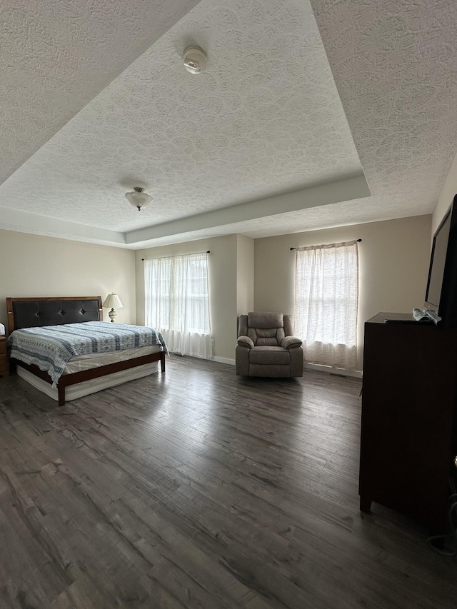8257 Ramstone Way, Antioch, TN 37013 - bedroom with a raised ceiling, a textured ceiling, wood finished floors, and baseboards
