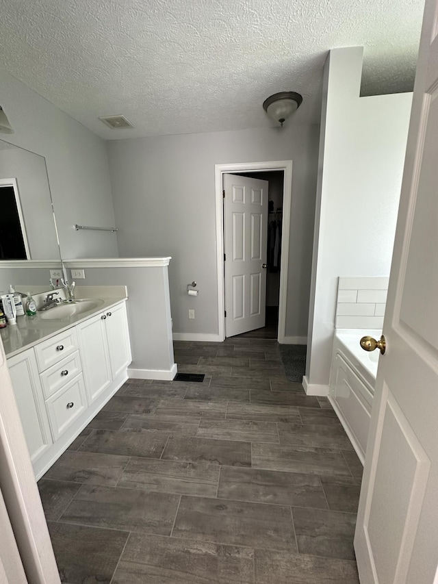 8257 Ramstone Way, Antioch, TN 37013 - bathroom with a bath, vanity, baseboards, and wood tiled floor