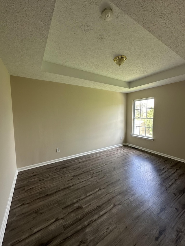 8257 Ramstone Way, Antioch, TN 37013 - unfurnished room featuring dark wood-type flooring, baseboards, and a raised ceiling