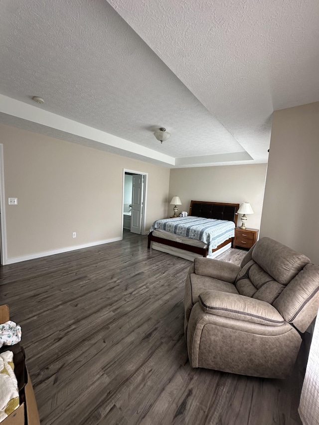 8257 Ramstone Way, Antioch, TN 37013 - bedroom featuring a textured ceiling, baseboards, and dark wood finished floors