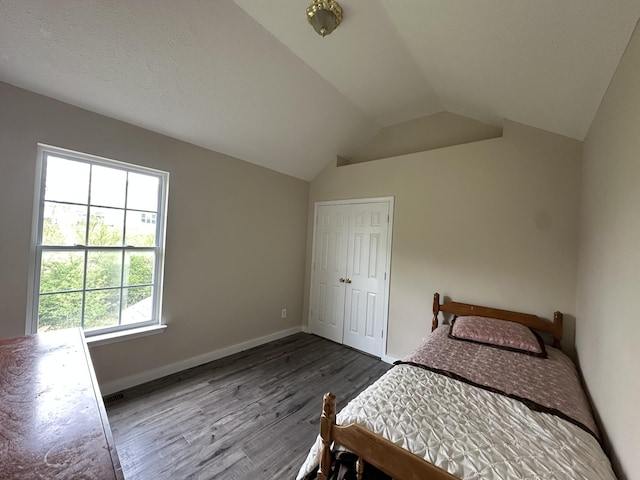 8257 Ramstone Way, Antioch, TN 37013 - bedroom with a closet, visible vents, vaulted ceiling, wood finished floors, and baseboards