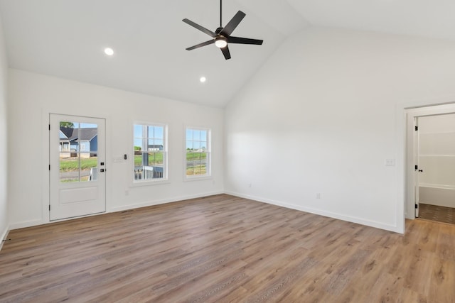 unfurnished living room with wood finished floors, baseboards, high vaulted ceiling, recessed lighting, and a ceiling fan