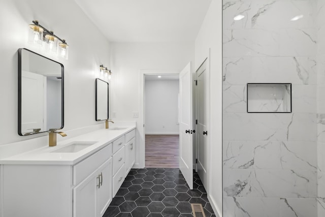 bathroom with a sink, tile patterned floors, double vanity, and visible vents