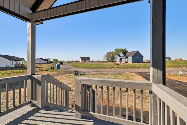 wooden terrace with covered porch and a rural view