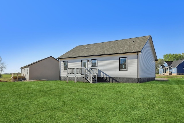 rear view of property with a lawn, a shingled roof, a deck, and crawl space