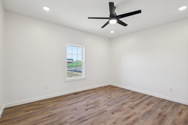 spare room featuring recessed lighting, baseboards, visible vents, and wood finished floors