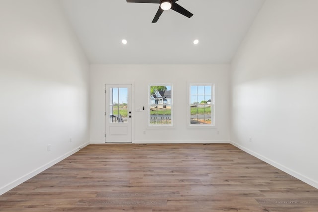 empty room with recessed lighting, a ceiling fan, baseboards, and high vaulted ceiling