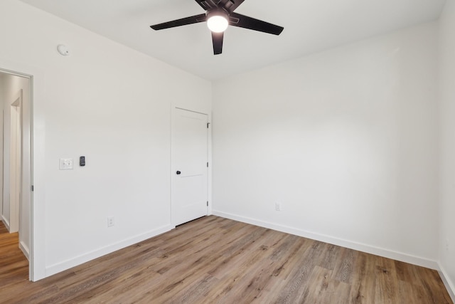 unfurnished room featuring baseboards, ceiling fan, and wood finished floors