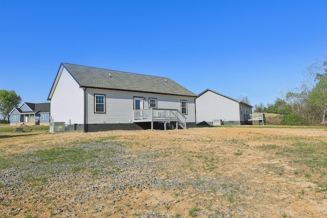 rear view of property with a wooden deck and central AC unit