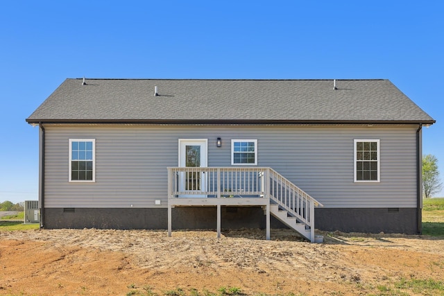 rear view of property featuring cooling unit, crawl space, and a deck