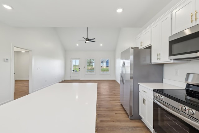 kitchen with a ceiling fan, appliances with stainless steel finishes, light wood finished floors, recessed lighting, and white cabinetry