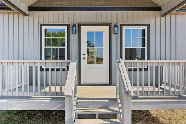 entrance to property with covered porch and board and batten siding