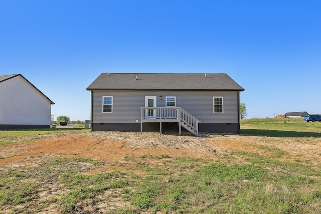 rear view of property with a wooden deck and crawl space