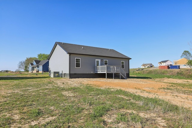 rear view of house with central air condition unit, a wooden deck, and crawl space
