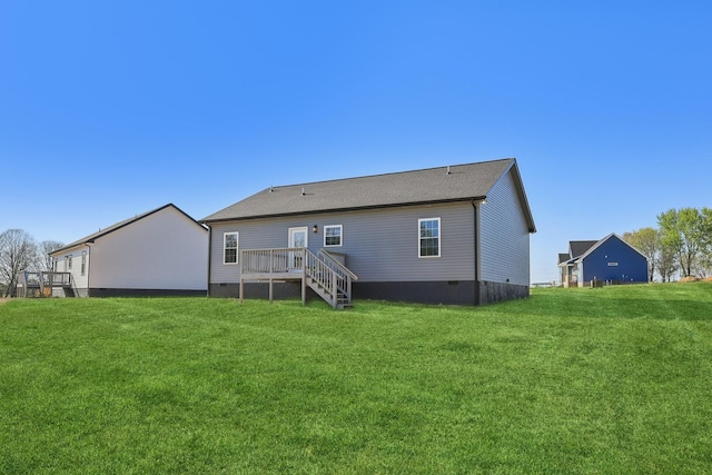 rear view of property with a yard, crawl space, and a deck