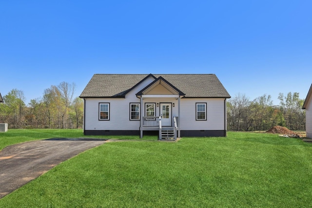 bungalow-style house featuring a shingled roof, a front lawn, and crawl space
