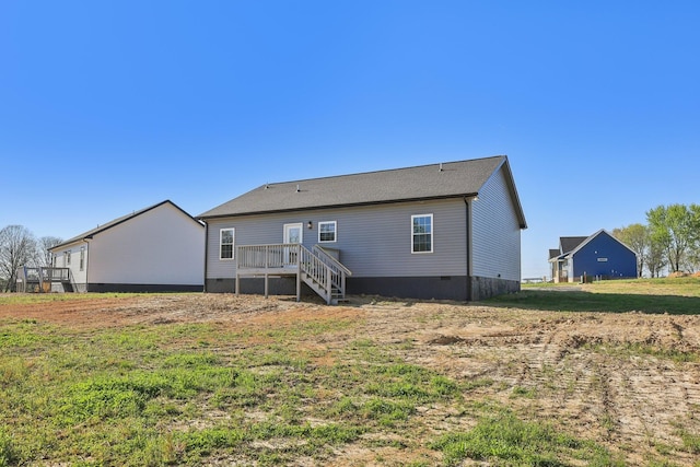 rear view of house with crawl space and a deck