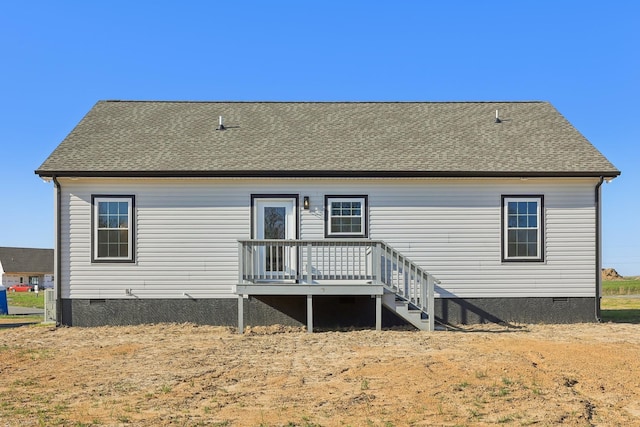 rear view of property featuring crawl space and roof with shingles