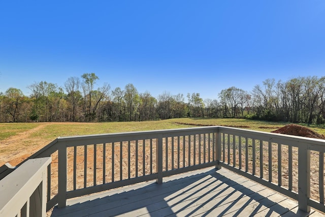 wooden deck featuring a yard