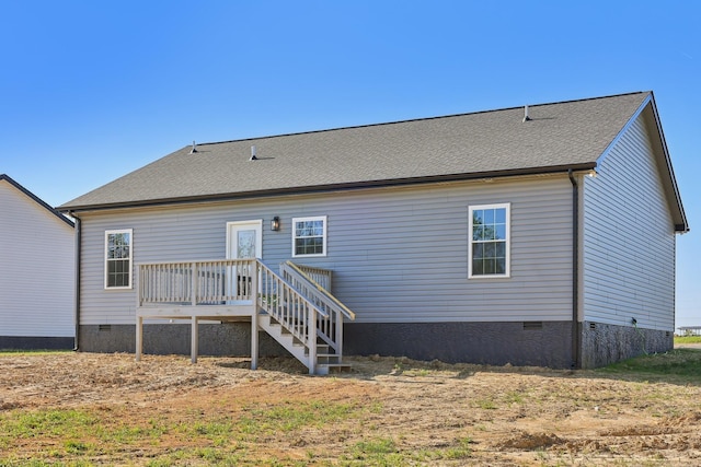 rear view of property featuring roof with shingles, crawl space, and a deck