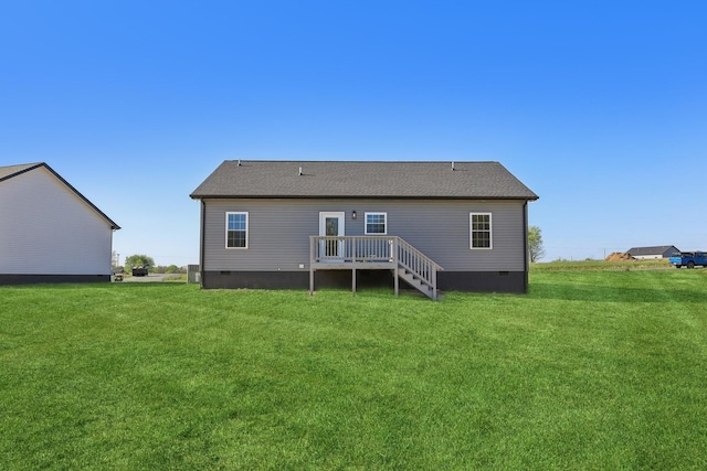 back of property with a wooden deck, a yard, and crawl space
