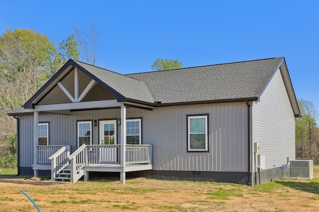 back of property featuring a shingled roof, cooling unit, a porch, and crawl space