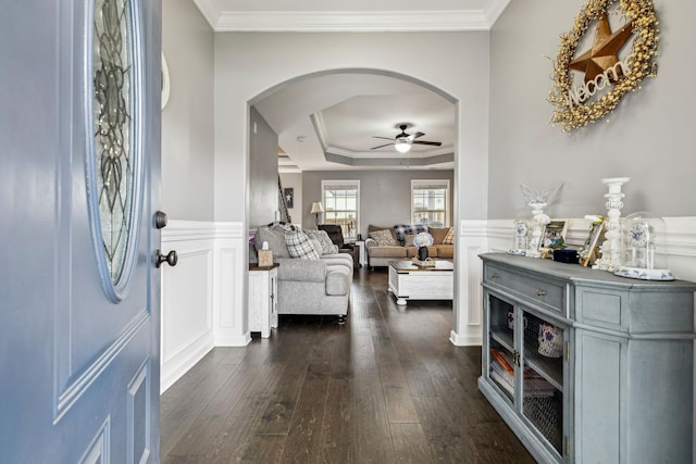 1328 Winterset Dr, Clarksville, TN 37040 - entrance foyer featuring arched walkways, a ceiling fan, dark wood-type flooring, ornamental molding, and a tray ceiling