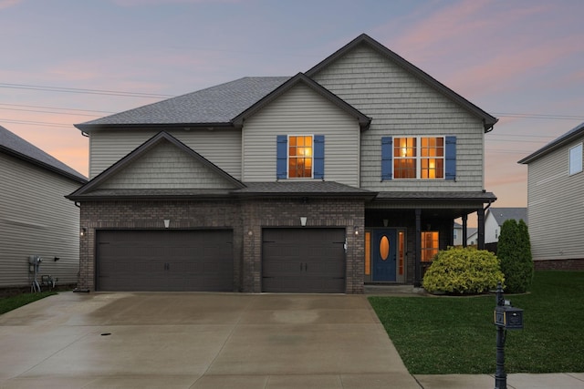 1328 Winterset Dr, Clarksville, TN 37040 - view of front of house with concrete driveway, a front lawn, brick siding, and a garage
