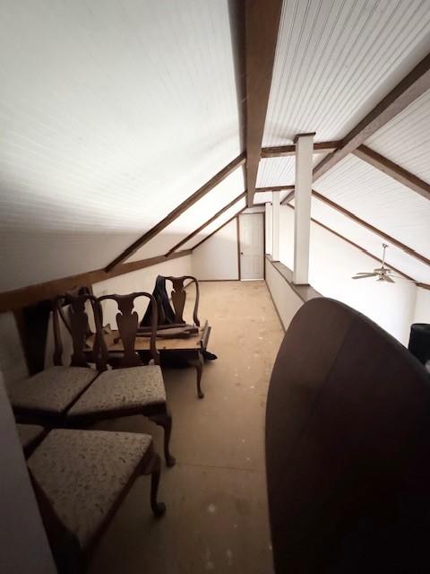additional living space featuring vaulted ceiling with beams