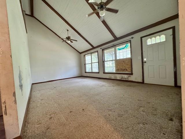 interior space featuring high vaulted ceiling, a ceiling fan, and carpet floors