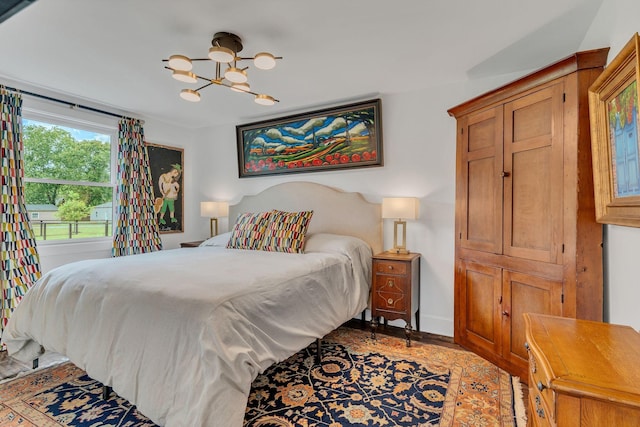 1561 Matlock Dr, Chapmansboro, TN 37035 - bedroom featuring a chandelier, baseboards, and wood finished floors