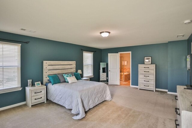 bedroom with visible vents, baseboards, and carpet