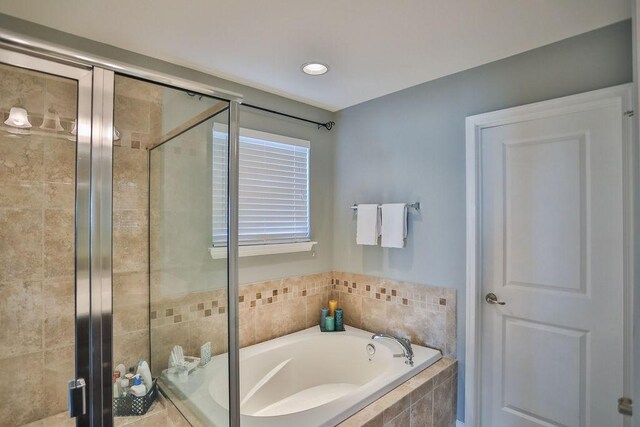 bathroom with a garden tub and a stall shower