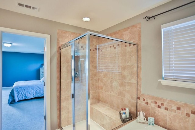 ensuite bathroom with ensuite bathroom, recessed lighting, a stall shower, and visible vents