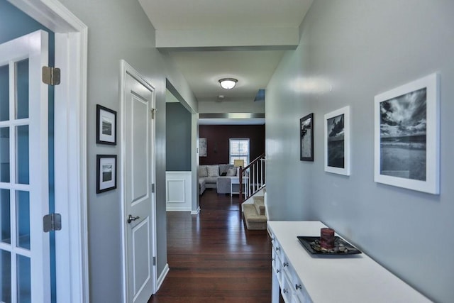 hallway featuring stairs and dark wood-type flooring